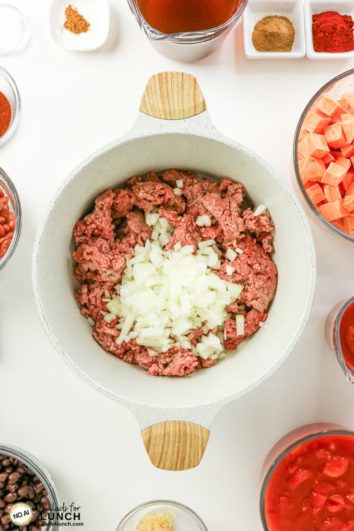 Healthy Sweet Potato Chili with Ground Beef - Sweet Potato Chili Process 12 Pot with raw ground beef and diced onion, surrounded by beans, diced sweet potato, tomatoes, and spices.