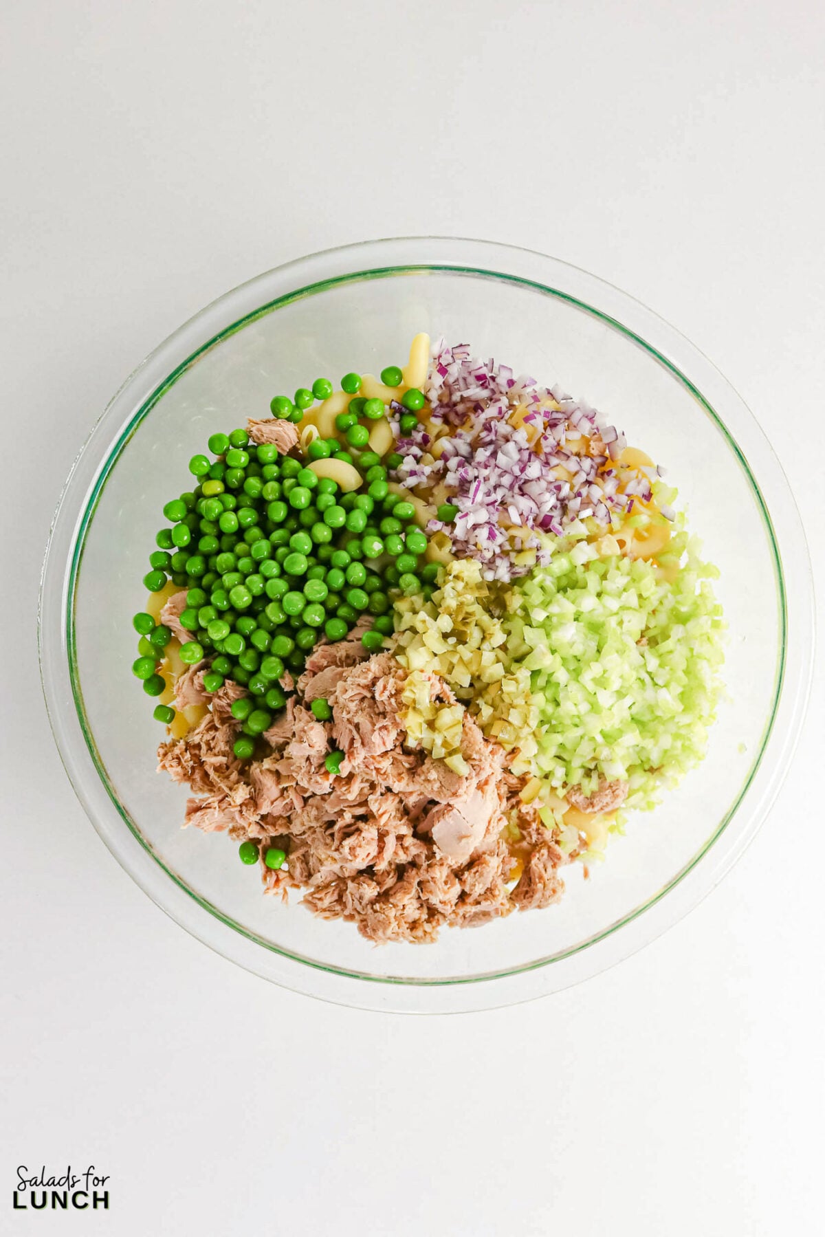 Creamy Tuna Macaroni Salad - Tuna Macaroni Salad Process 8 Bowl with cooled macaroni topped with peas, tuna, red onion, celery and chopped pickles before mixing with dressing.