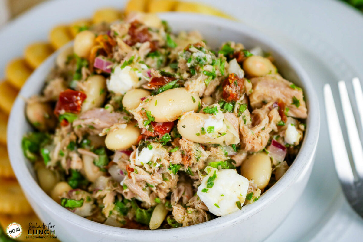Tuscan Tuna Salad - Tuscan Tuna Salad Hero 10 Bowl of Tuscan tuna salad with cannellini beans, sun-dried tomatoes, goat cheese and herbs, served with crackers.